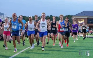 Runners leave the start on the Richmond Hill High School stadium turf at Heartwood's Run for the Hill 5K, October 17, 2026